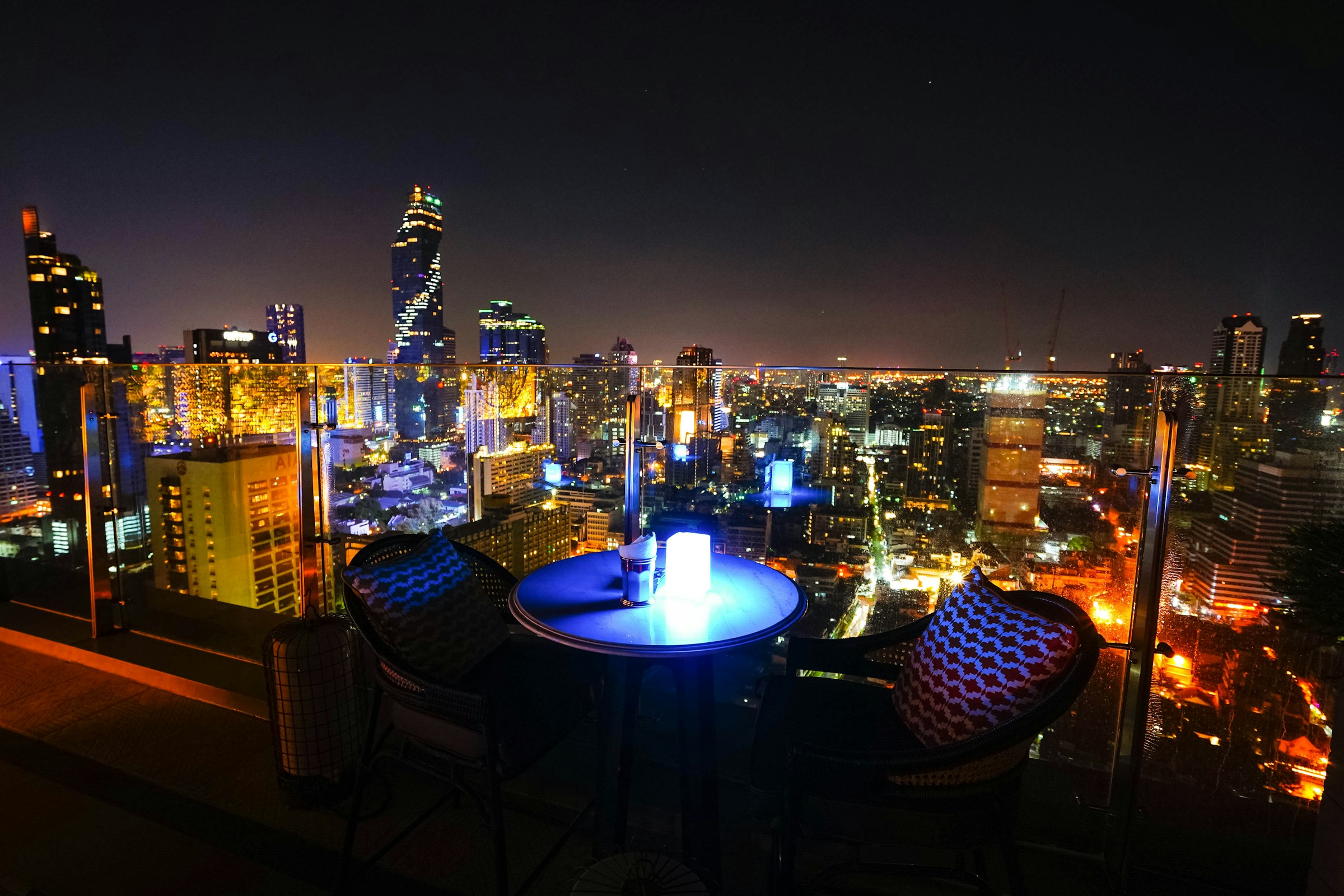 Night rooftop overlooking city lights — hospitality sample atmosphere